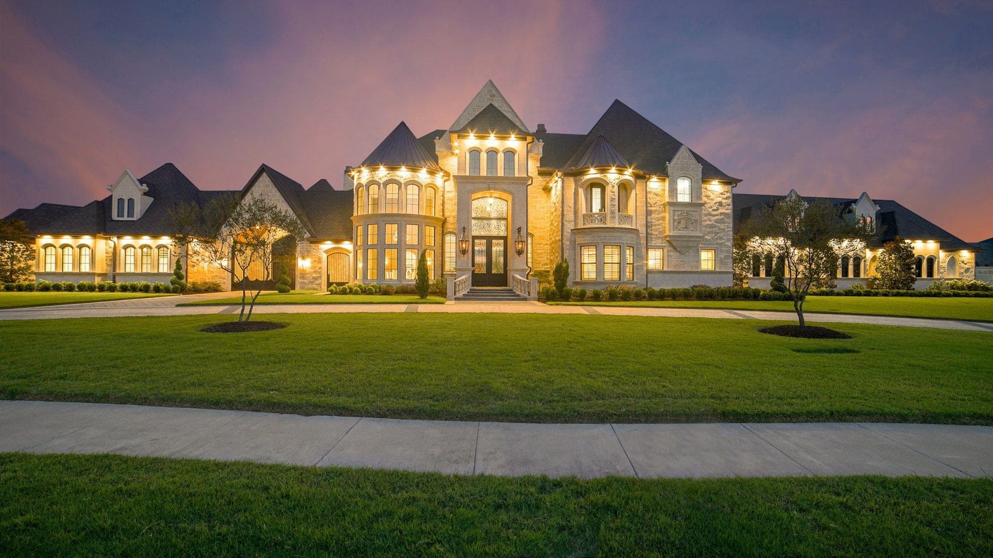 Luxury estate lit at dusk